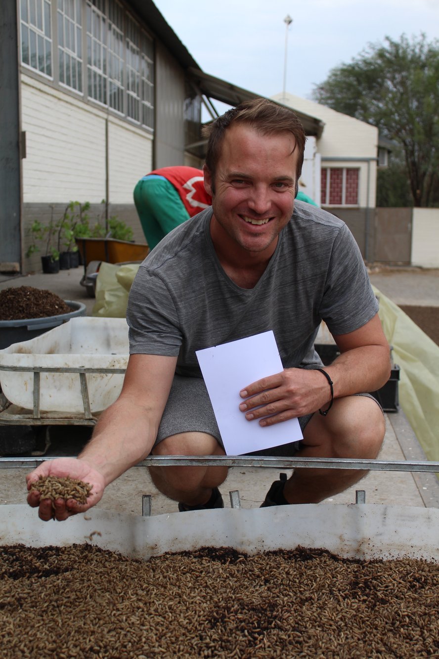 Man with biocycle products, black dragon fly, Namibia
